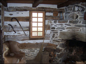 Swedish Cabin - The corner fireplace in the East Room of the Swedish Log Cabin. 